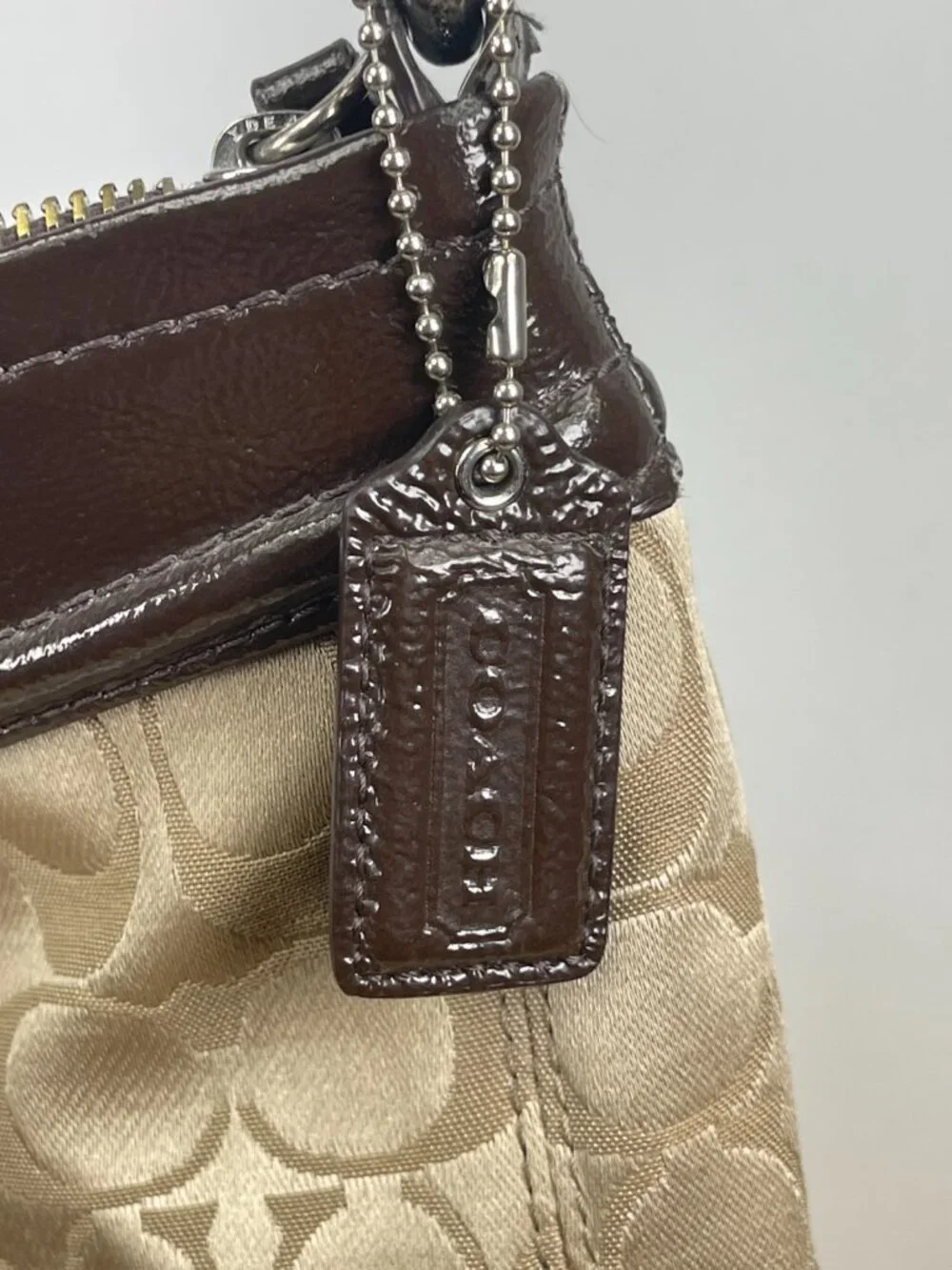 Classic older-era Coach Signature hobo bag featuring jacquard canvas and patent